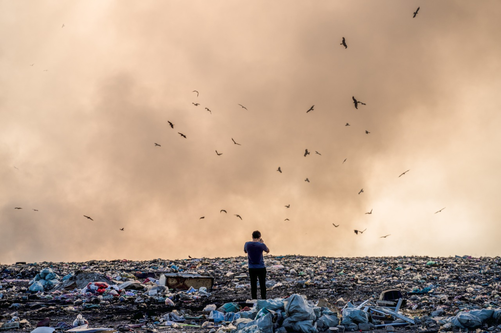 man on a landfill searching his lost cold wallets.